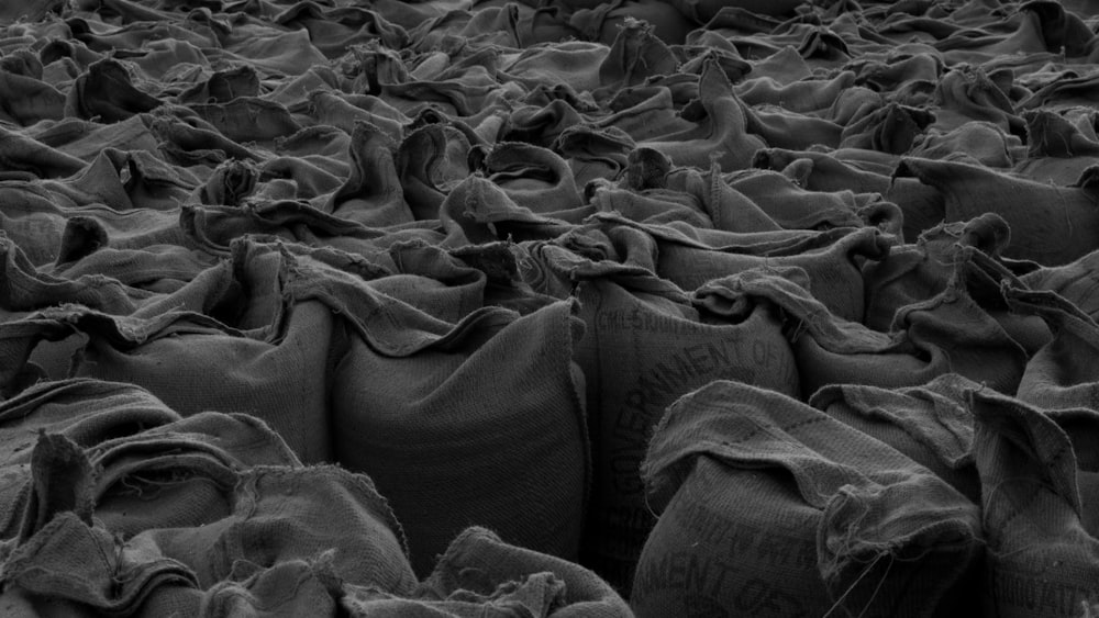 a black and white photo of bags of sand