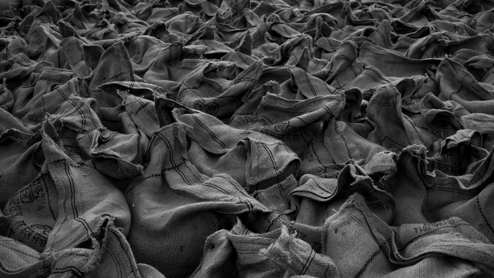 a large group of cloth bags sitting on top of a floor