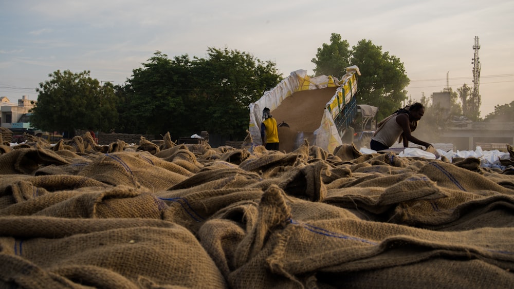 a large amount of bags of sand sitting on the ground