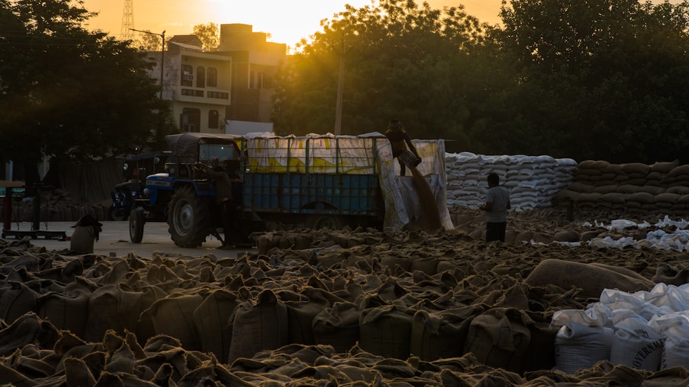 a large pile of sand next to a truck