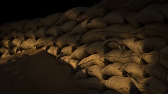 a pile of sand sitting next to a pile of bags