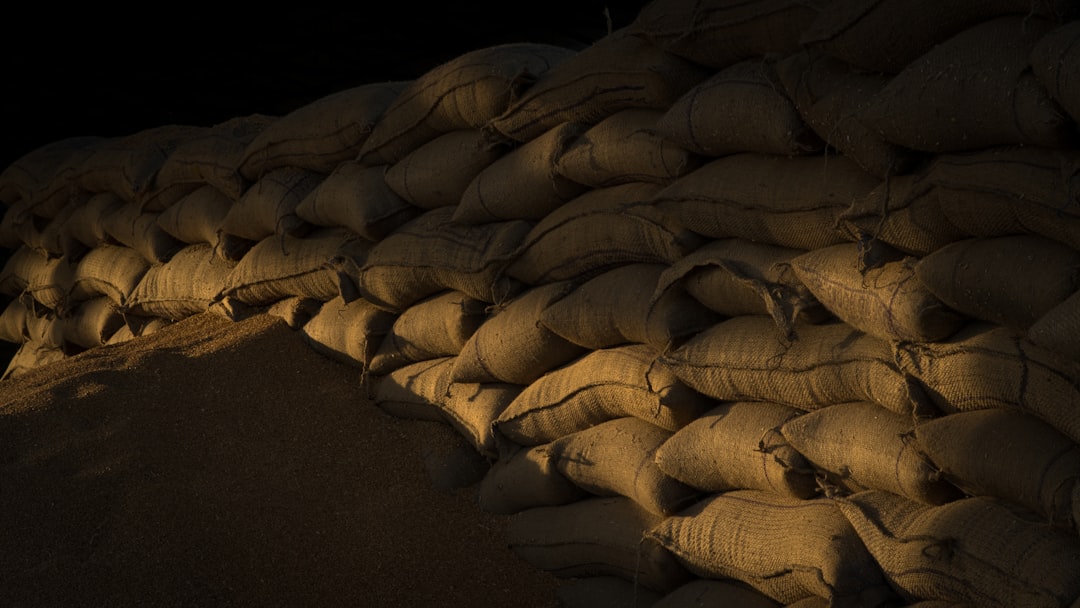 a pile of sand sitting next to a pile of bags,