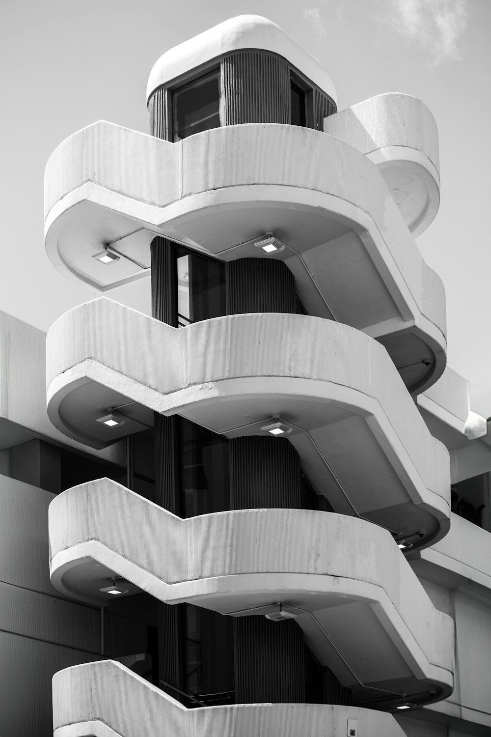 a black and white photo of a building with balconies