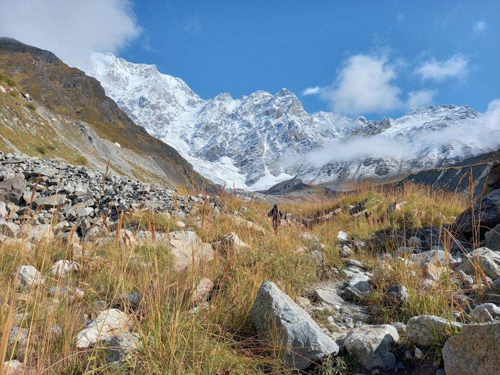 a man hiking up a rocky trail in the mountains