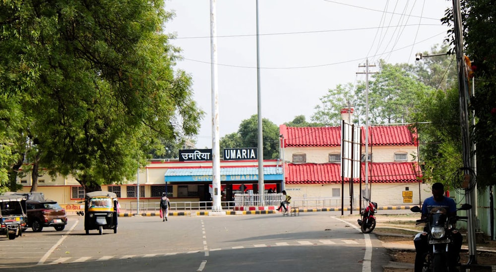 a man riding a motorcycle down the middle of a street