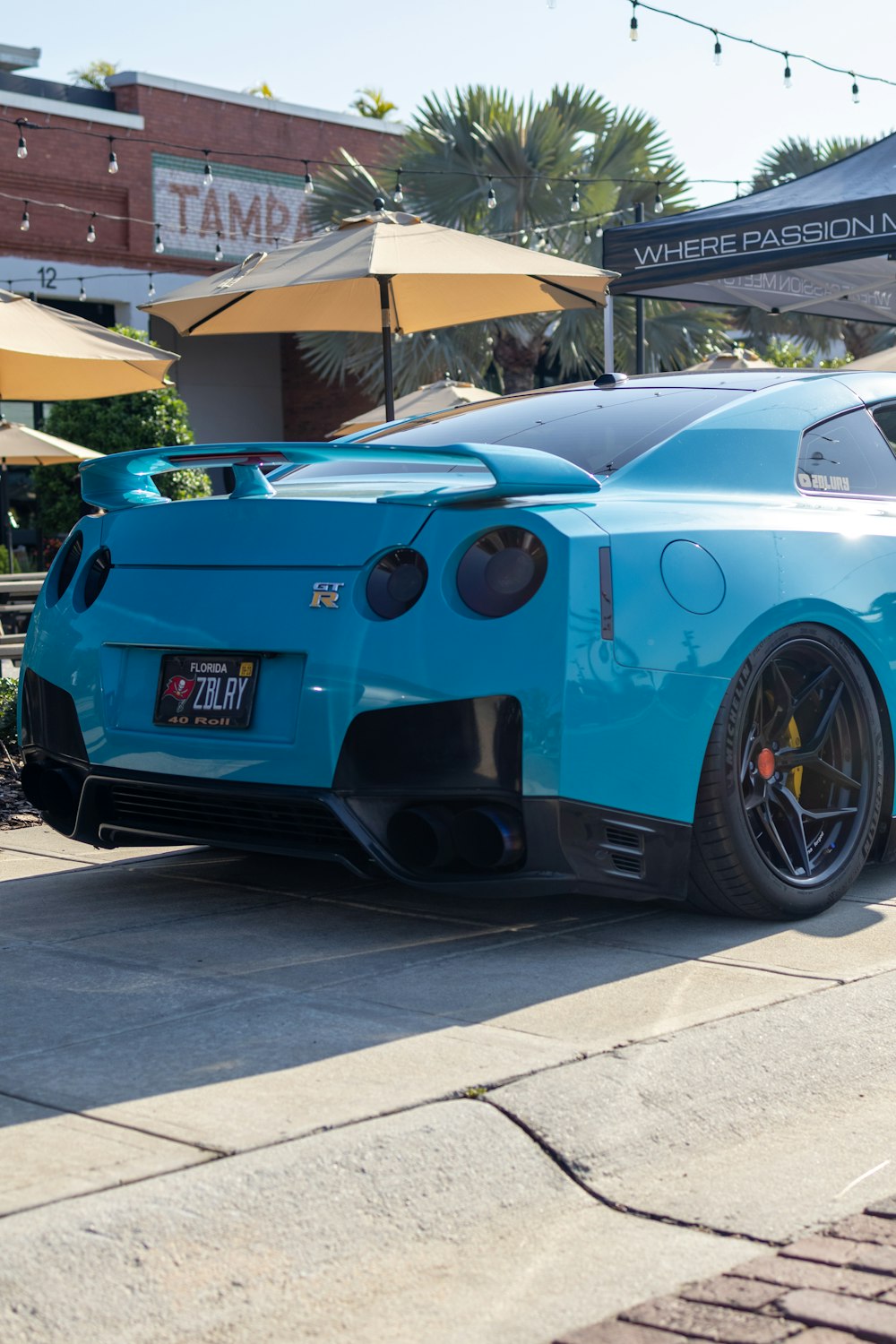 a blue sports car parked on the side of the road