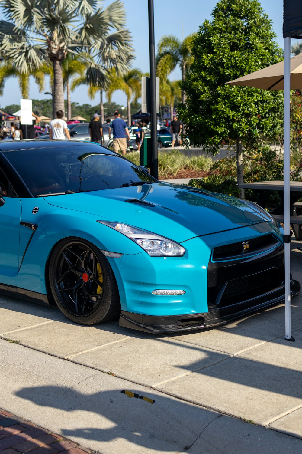 a blue sports car parked on the side of the road