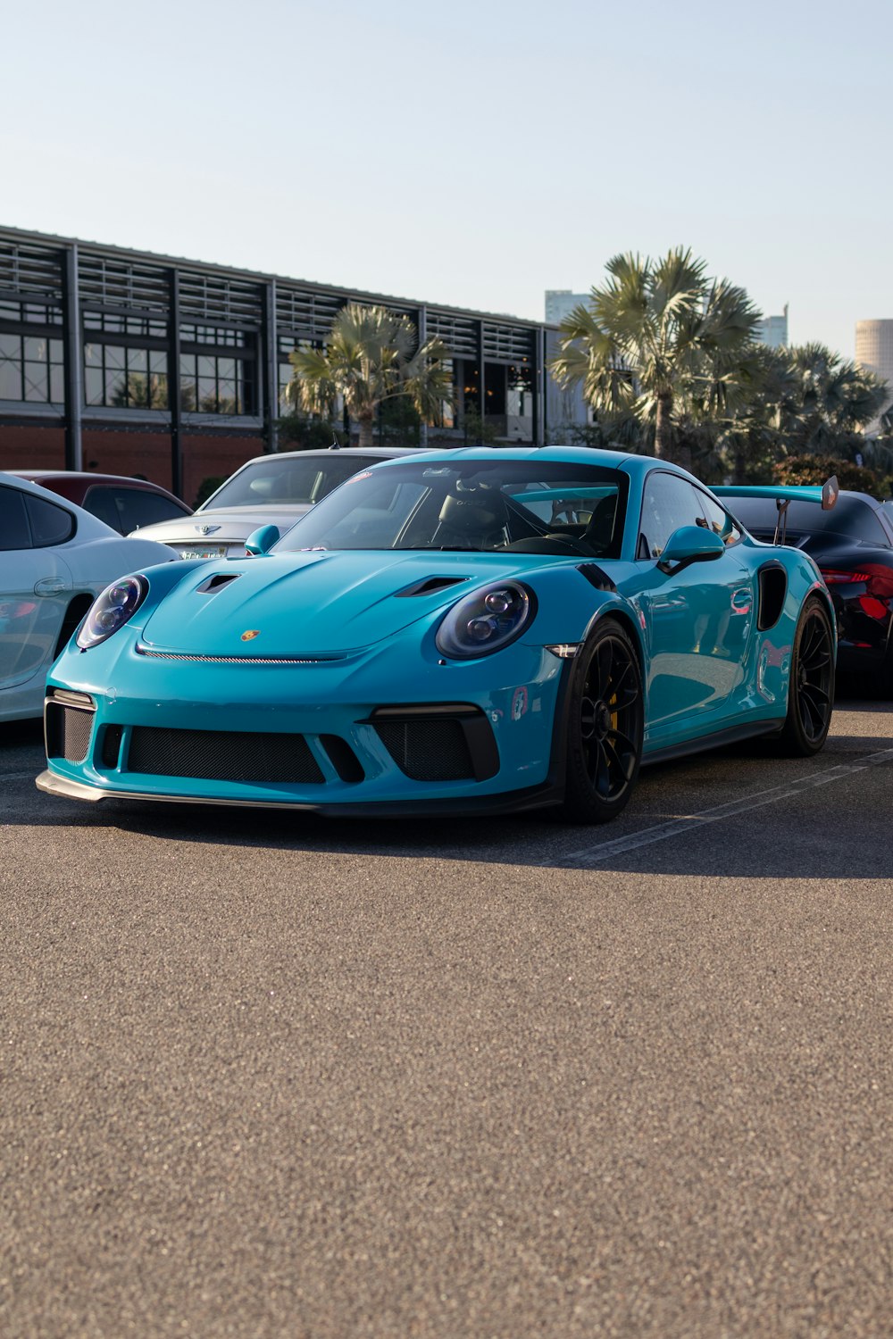 a blue sports car parked in a parking lot