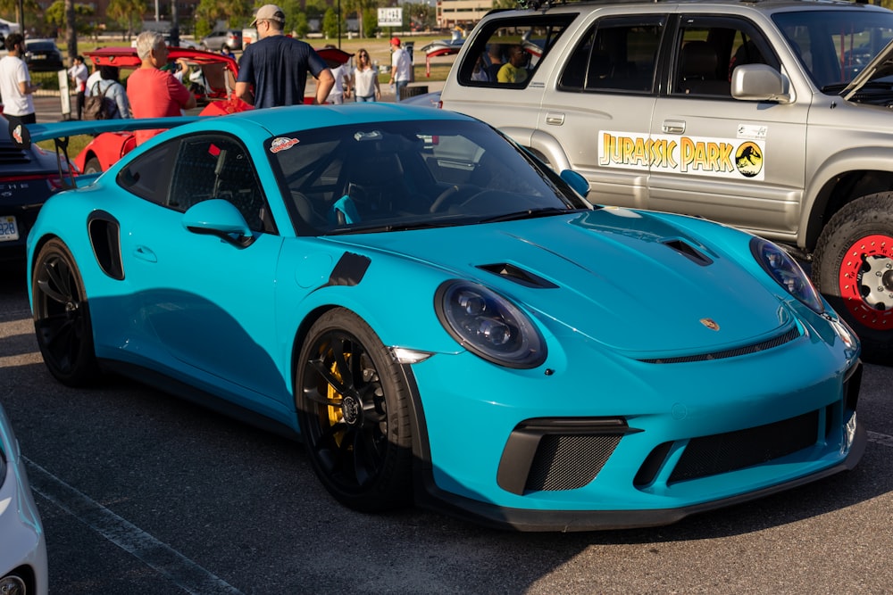 a blue sports car parked in a parking lot