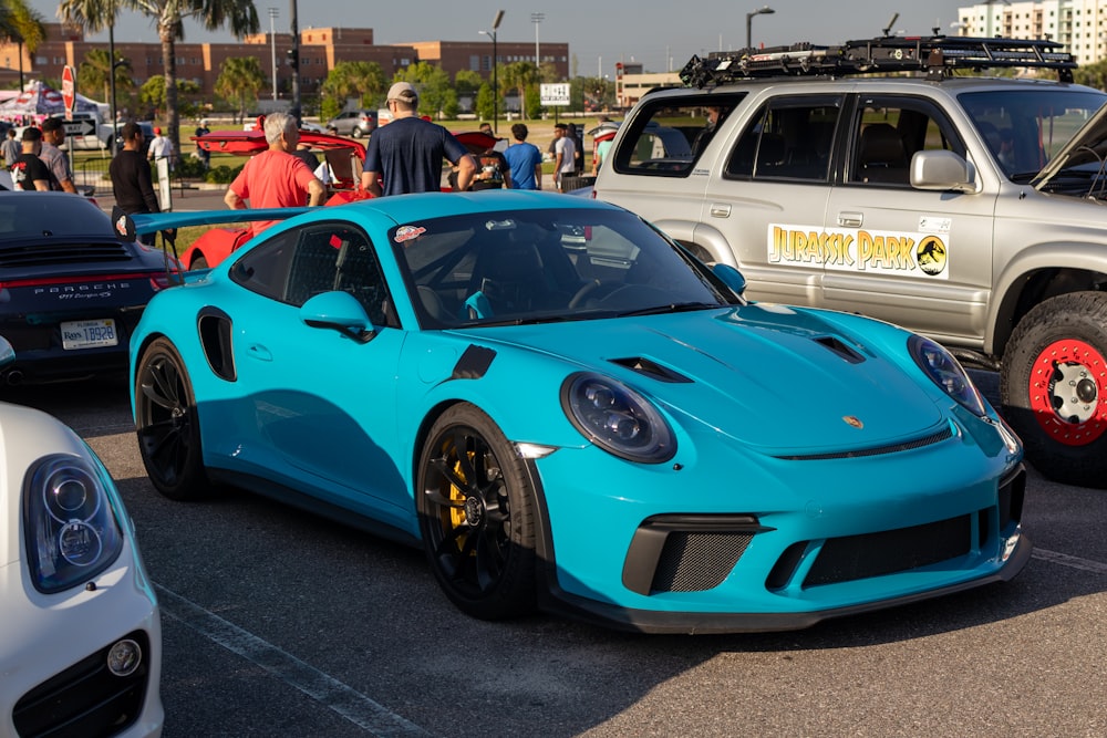 a blue sports car parked in a parking lot