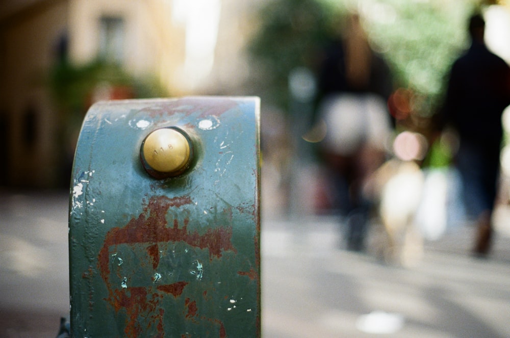 a close up of a metal object on a city street