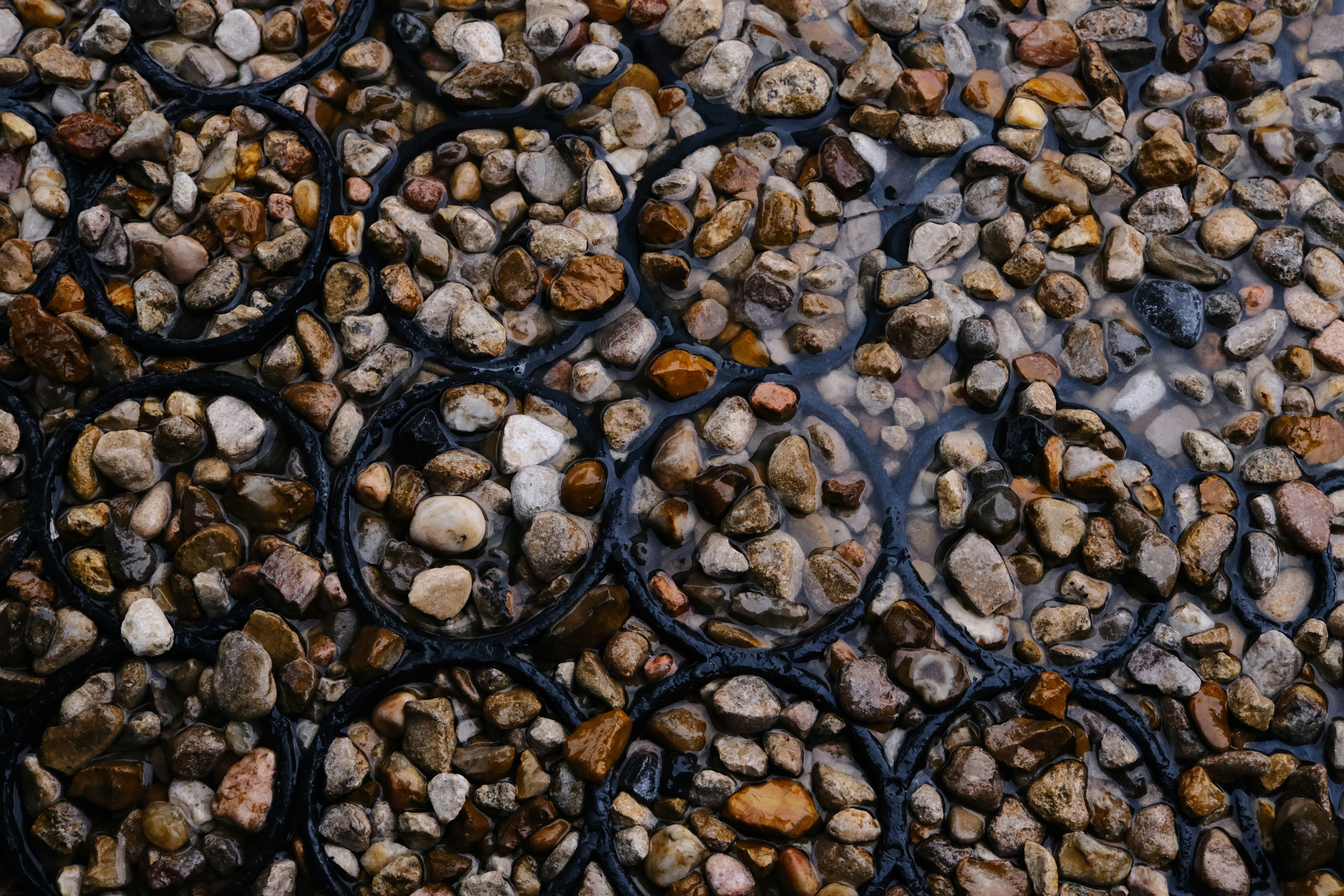 A bunch of rocks sitting on top of a body of water photo – Free Road ...
