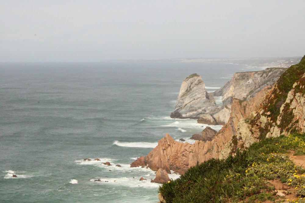 a view of the ocean from the top of a hill