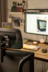 a computer desk with a monitor and keyboard