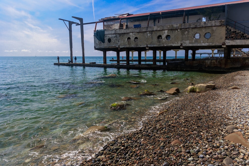 a boat sitting on top of a pier next to the ocean