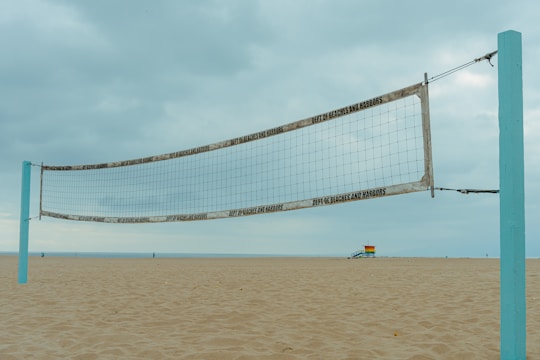 a beach volleyball net on a sandy beach