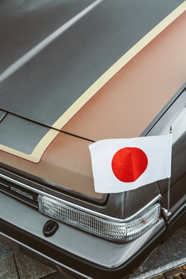 a car with a japanese flag on the hood