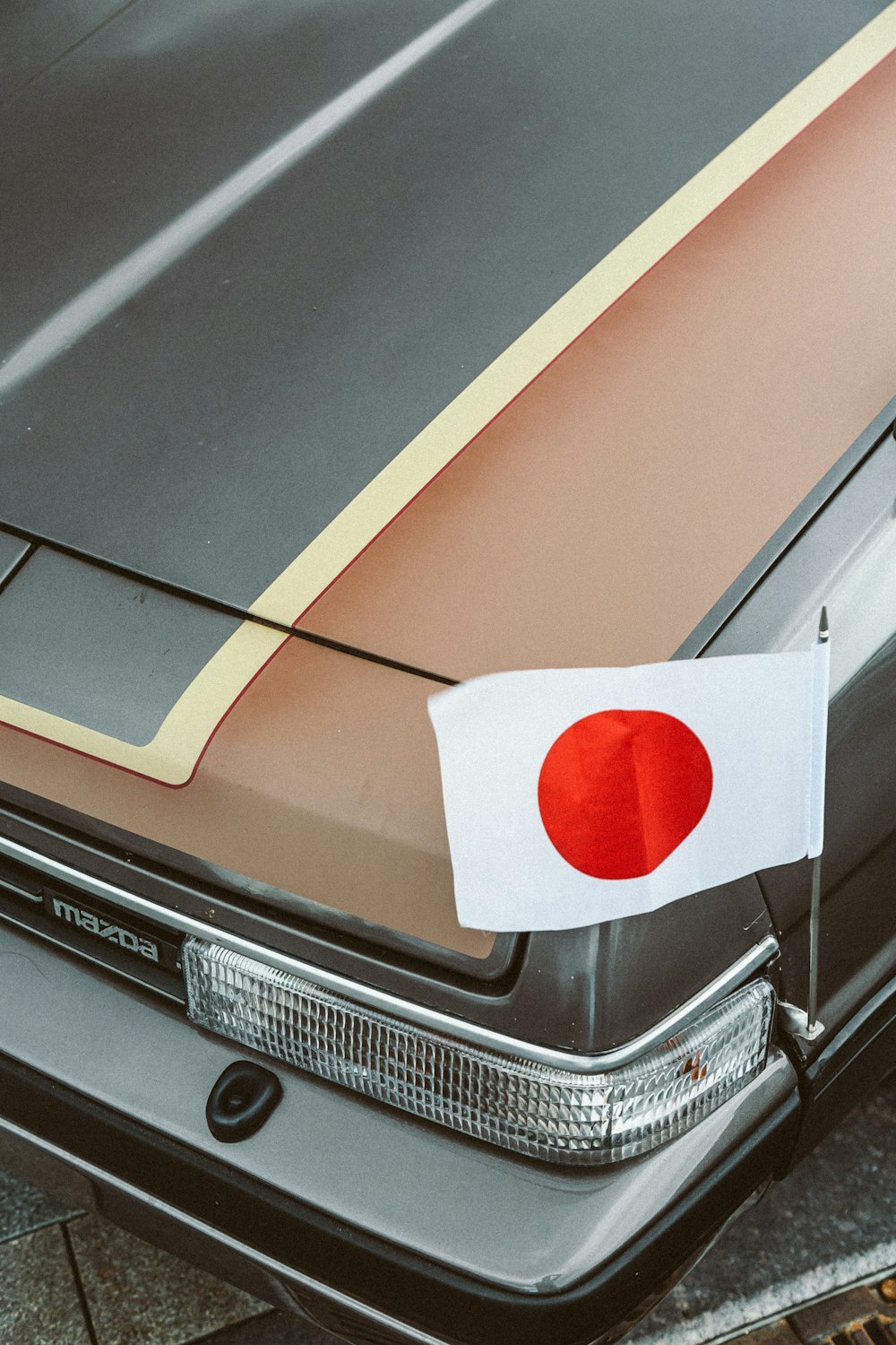 a car with a japanese flag on the hood