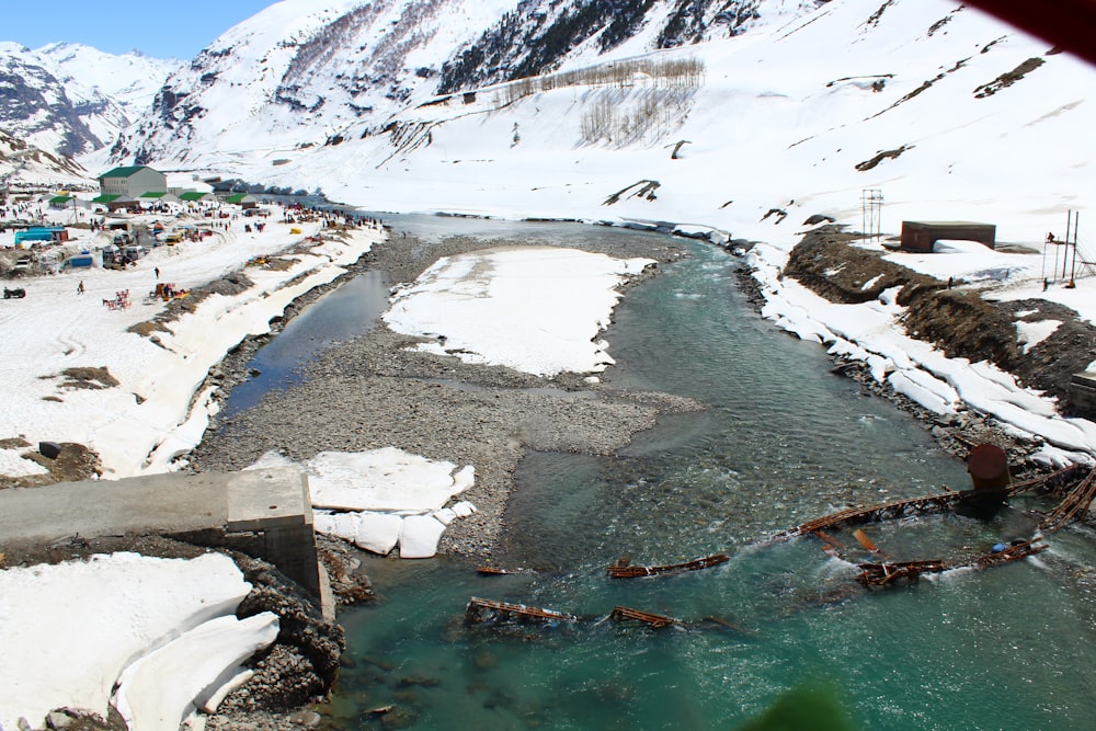 a river running through a snow covered mountain side