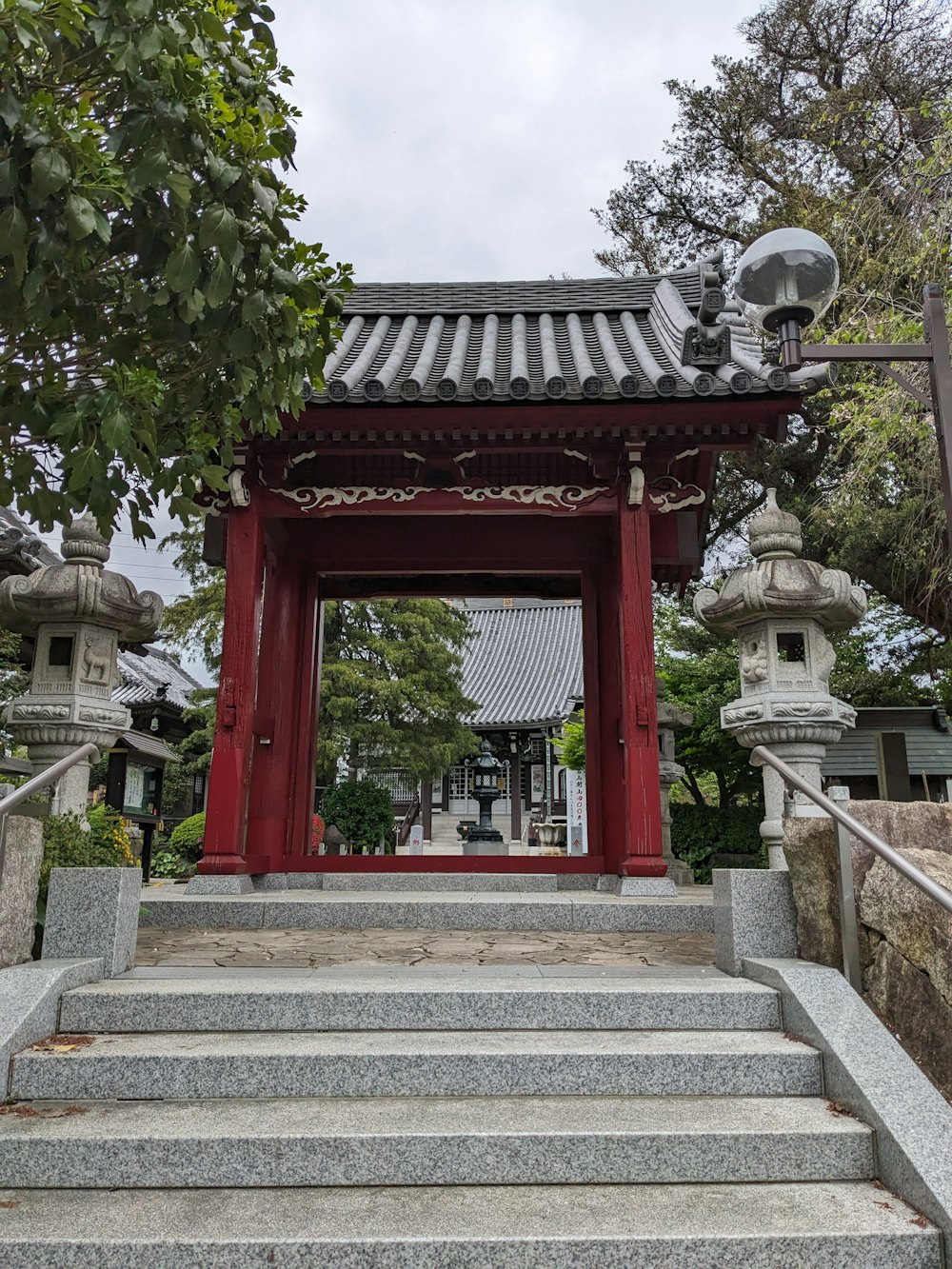 a red gate with steps leading up to it