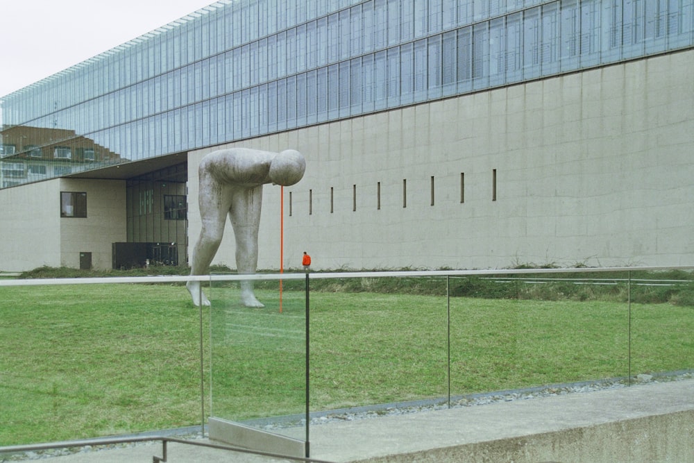 a large white sculpture in front of a building