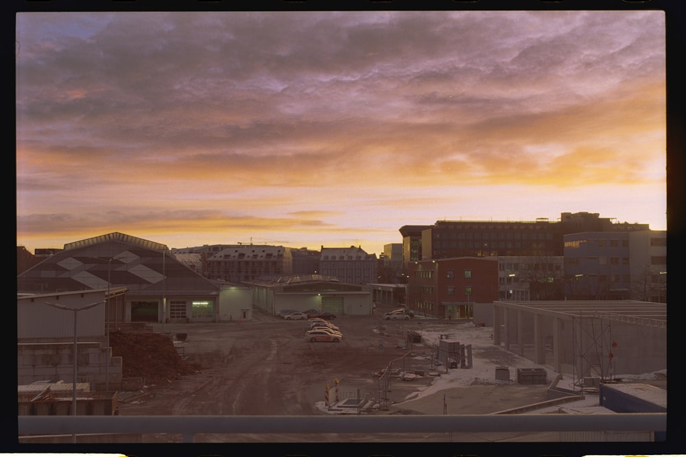 a view of a city from a window at sunset