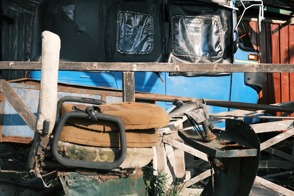 a pile of junk sitting next to a blue train