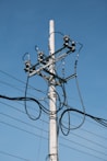 a telephone pole with multiple wires attached to it
