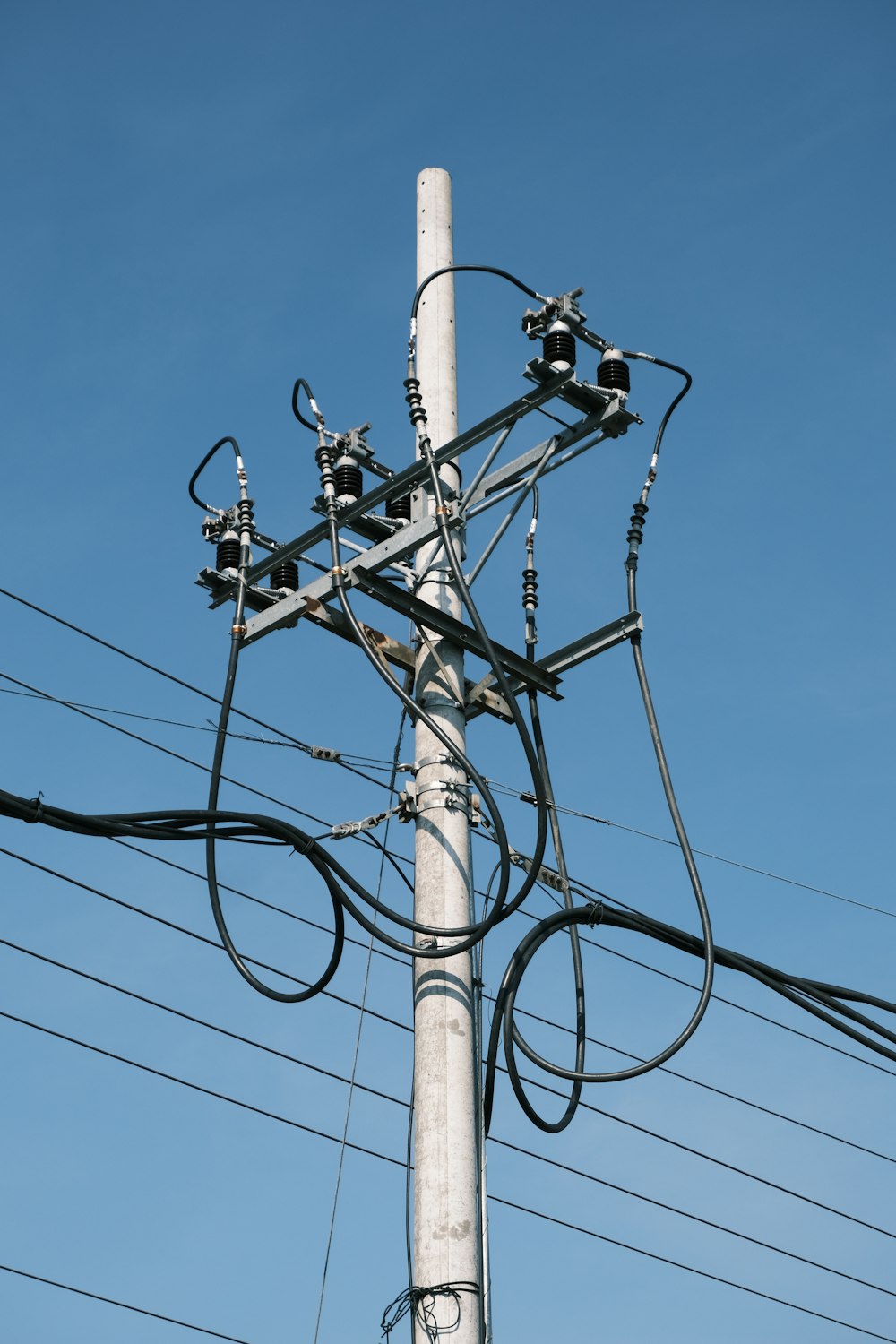 a telephone pole with multiple wires attached to it