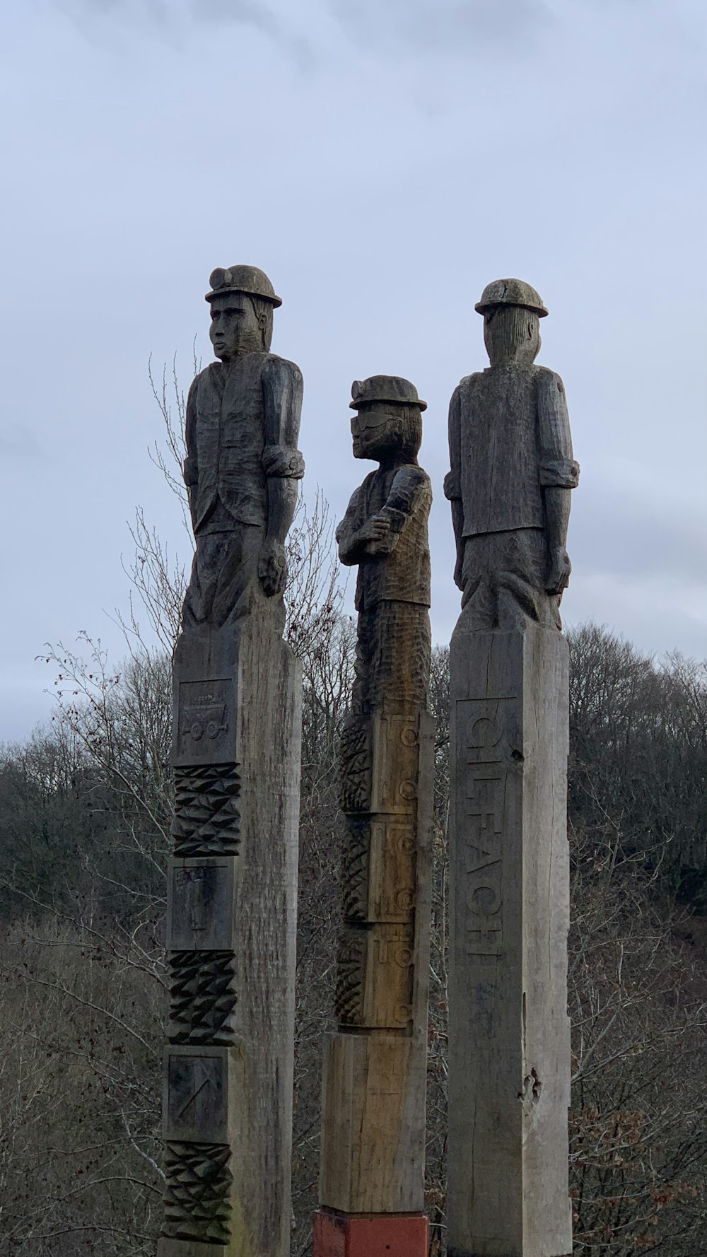 a group of statues of men standing next to each other