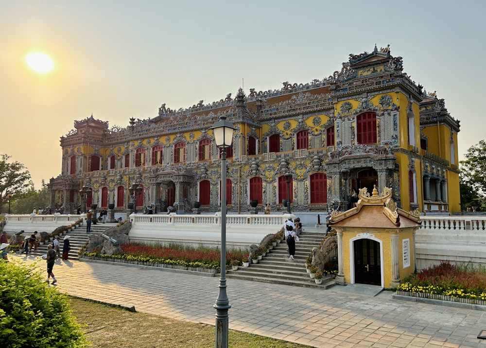 a yellow and white building with red shutters