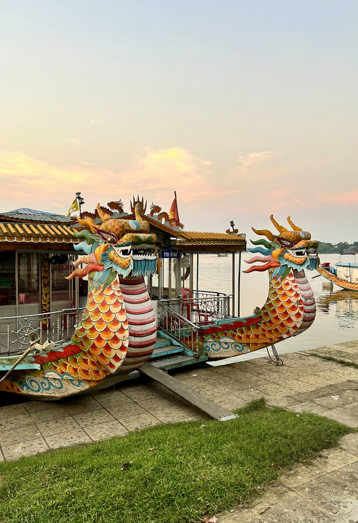 Imperial Citadel Hue — tourist boat on the Perfume River beside the citadel walls