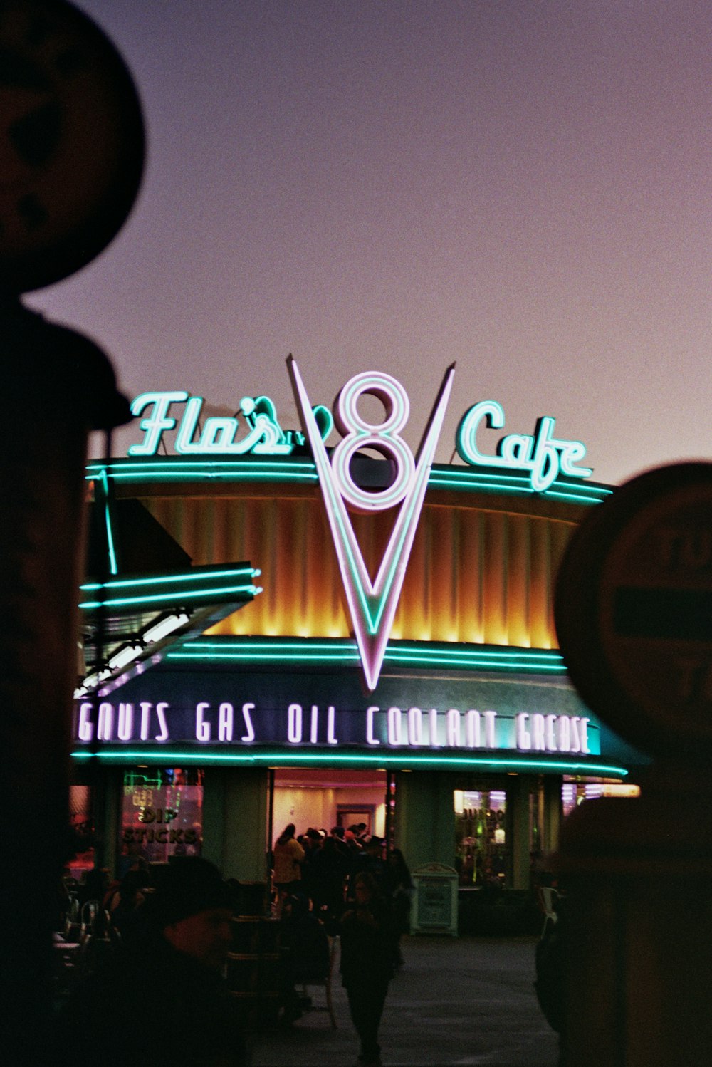 a building with a neon sign that says flix's 8 cafe