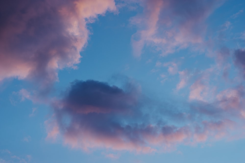 a plane flying in the sky with a lot of clouds