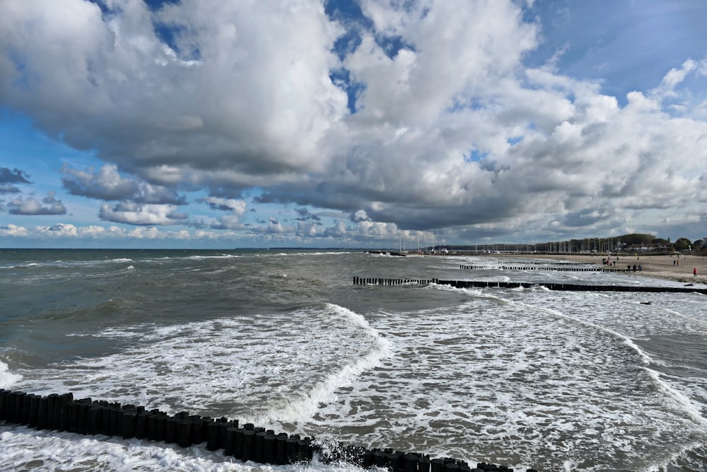 a view of a beach with waves coming in to shore