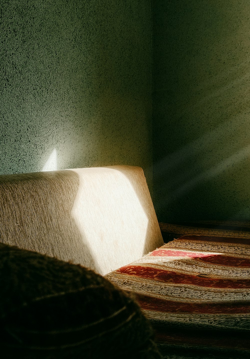 a room with a bed and a rug on the floor