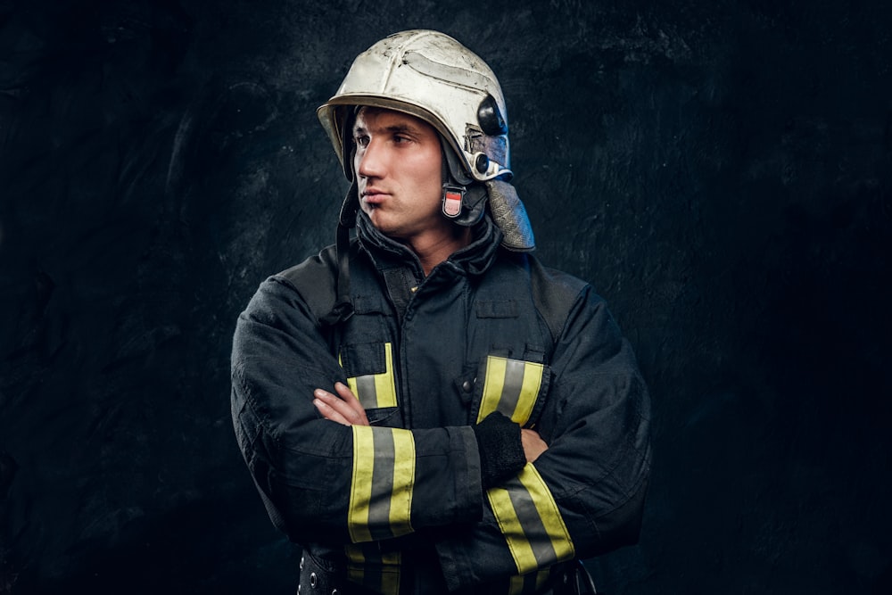 a man in a fireman's uniform with his arms crossed