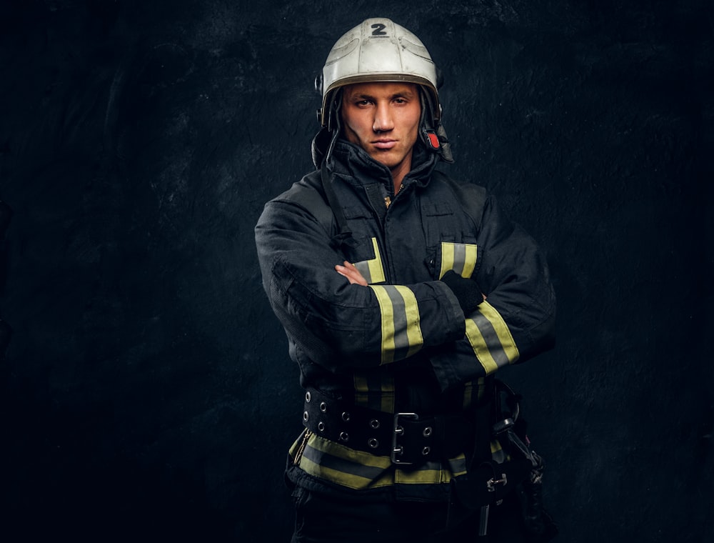 a man in a fireman's uniform with his arms crossed