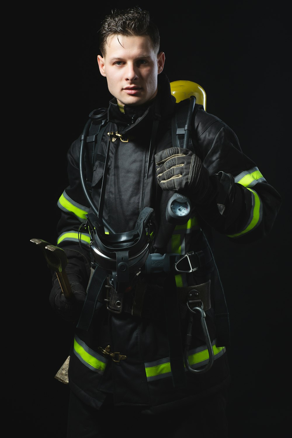 a man in a firefighter's uniform holding a tool