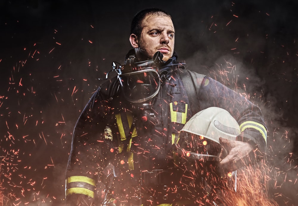 a man in a firefighter's uniform holding a fire extinguisher