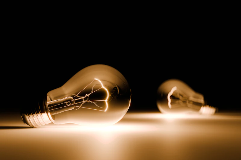 A couple of light bulbs sitting on top of a table
