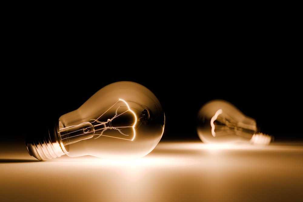 a couple of light bulbs sitting on top of a table