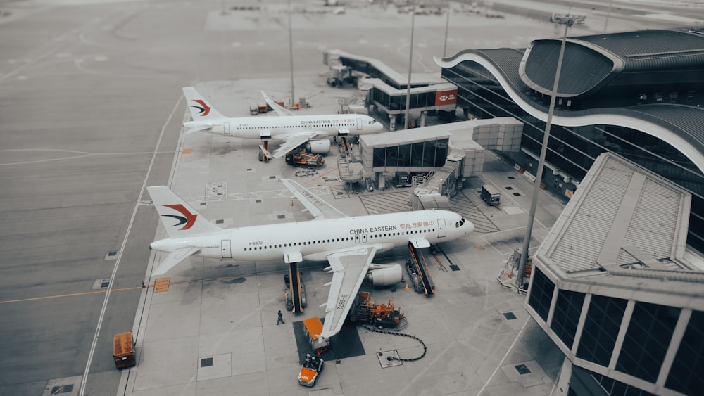 a couple of airplanes that are on a runway