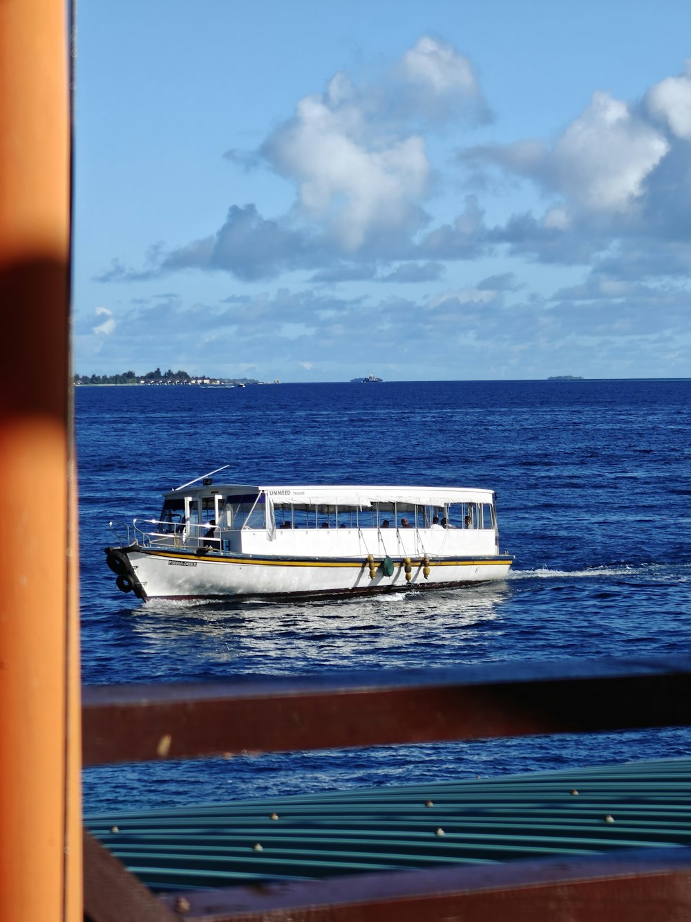 a white boat traveling across a large body of water