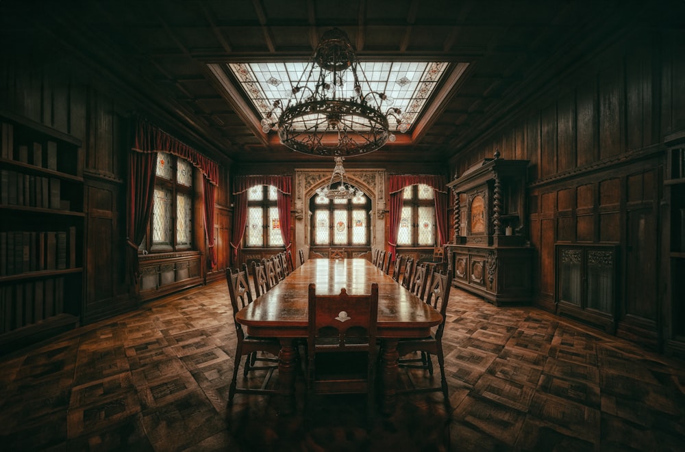 a dining room with a large wooden table and chairs