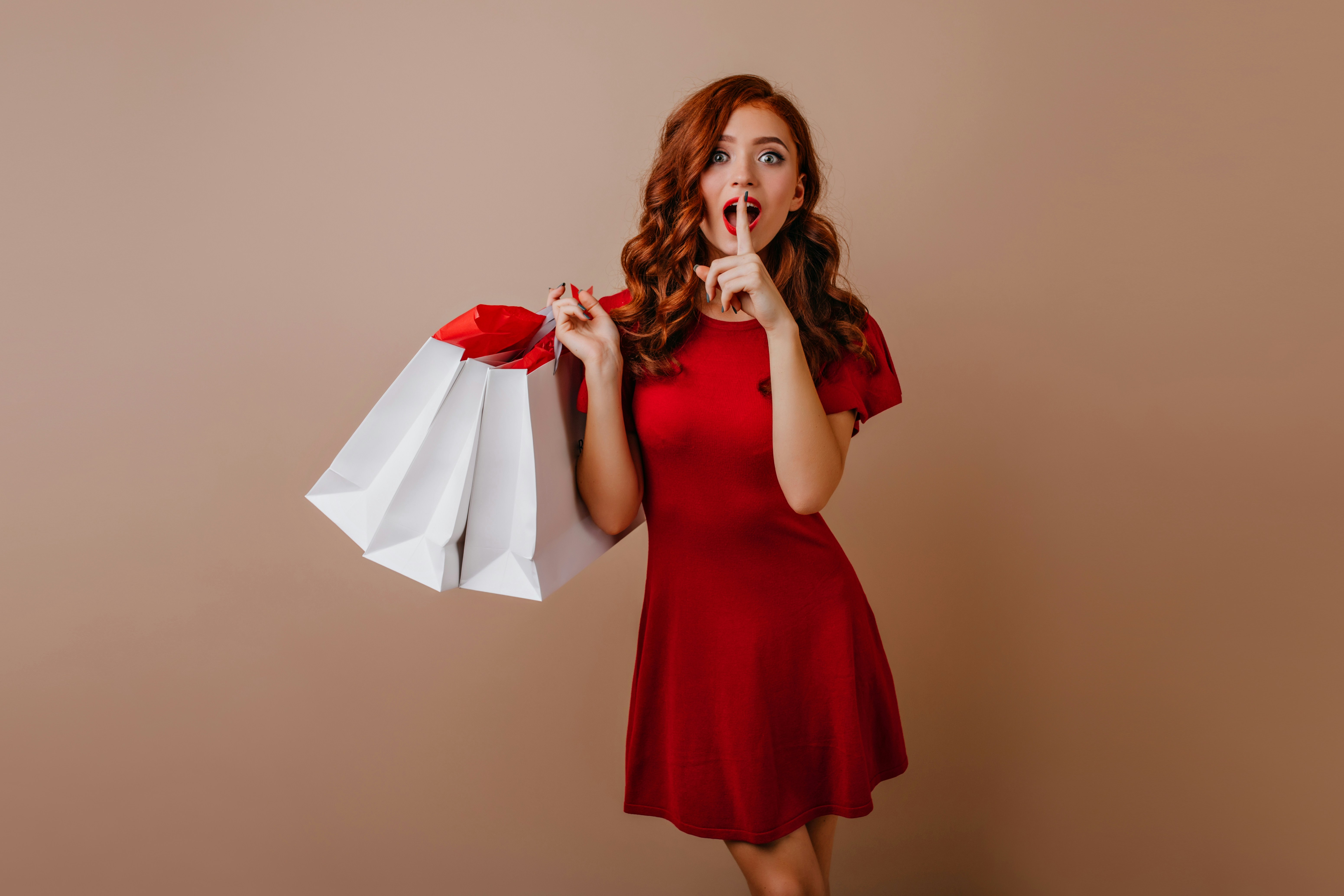 How to Bounce Back from a Slow Sales Month Without Panicking – a woman in a red dress holding shopping bags