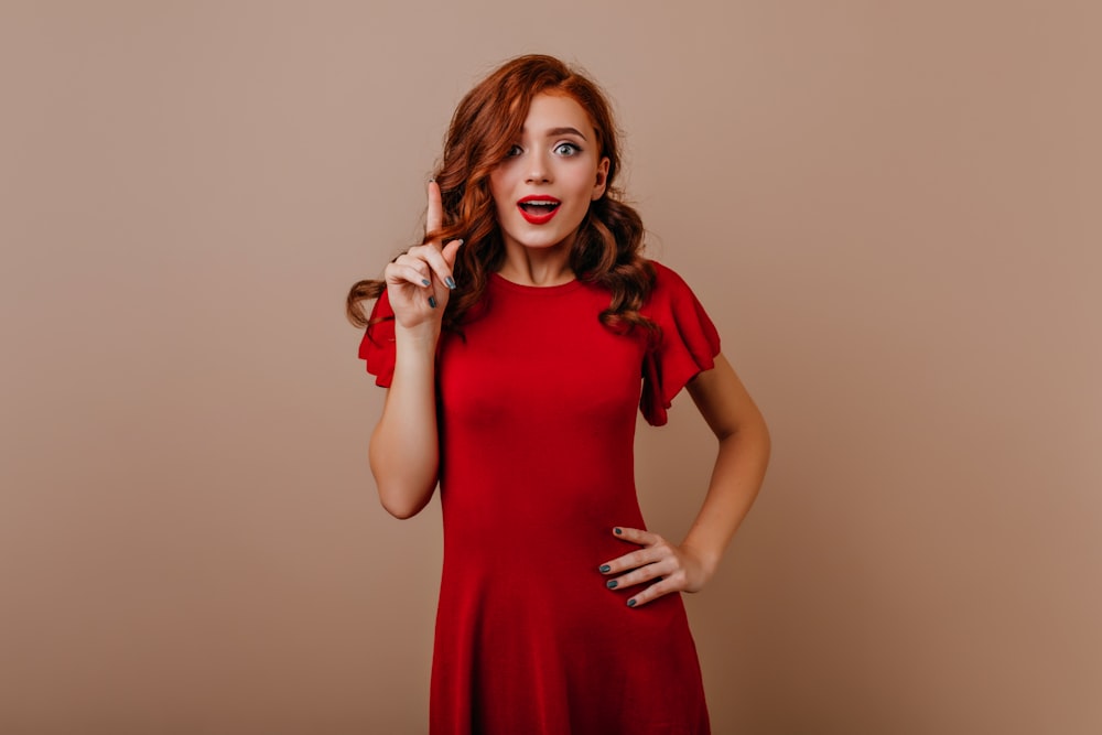 a woman in a red dress posing for a picture