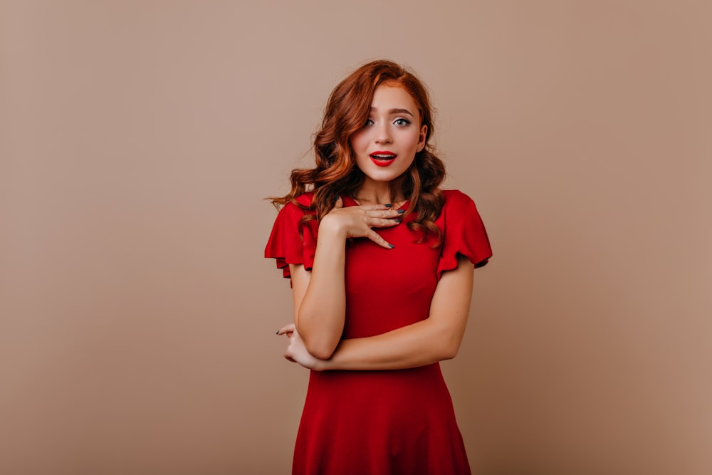 a woman in a red dress posing for a picture