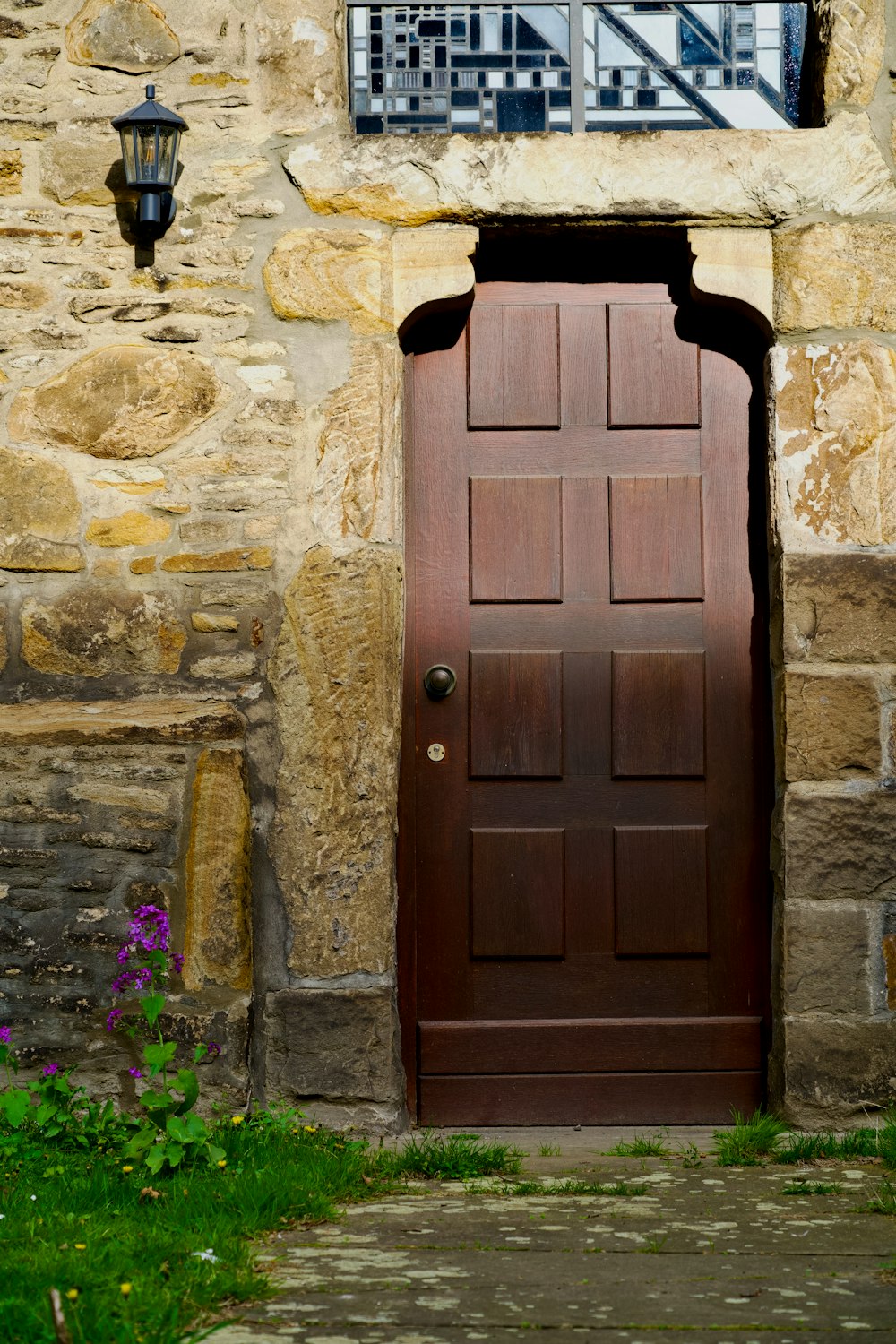 a wooden door with a window above it