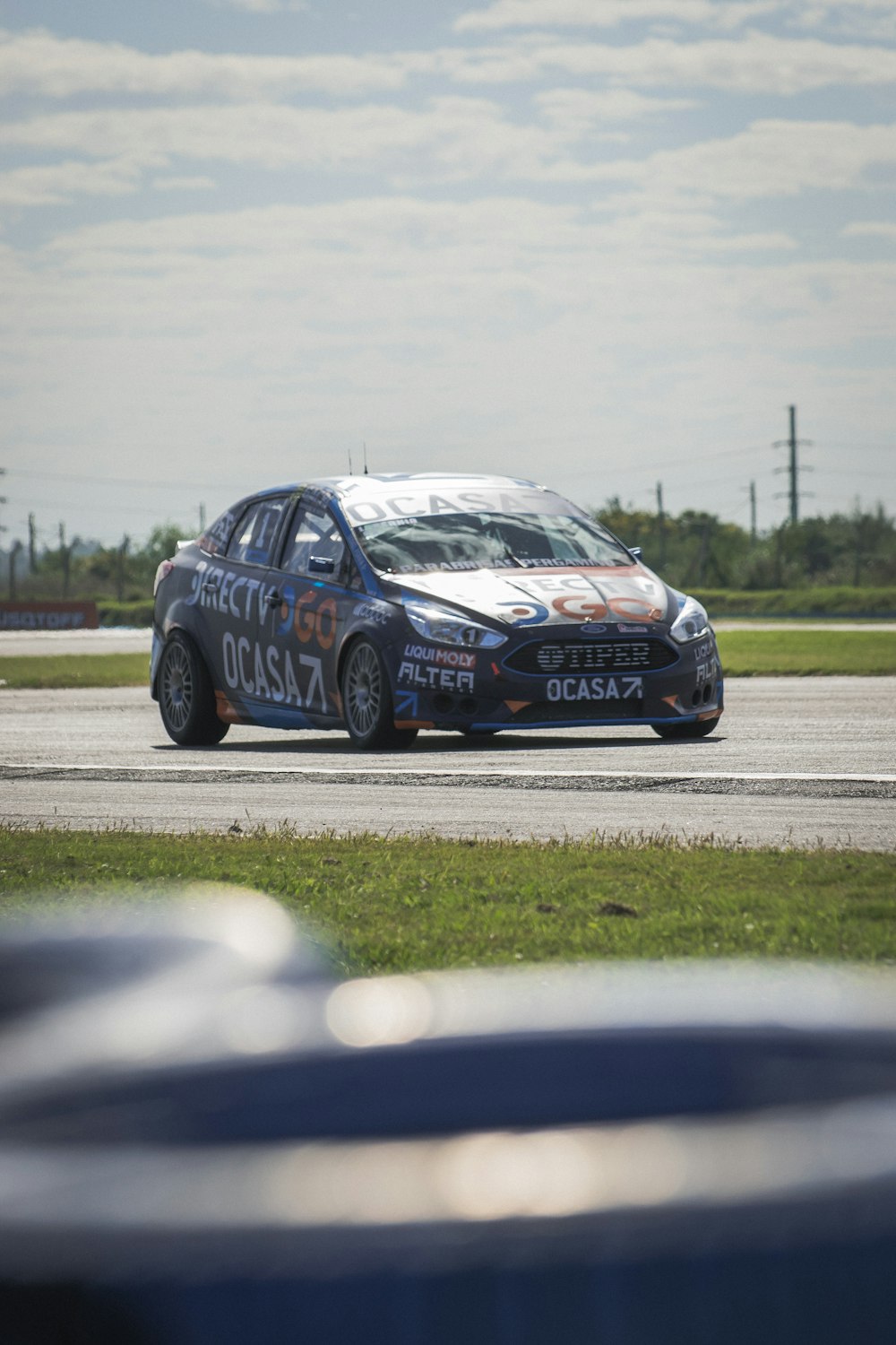 a car driving on a race track during the day